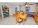 Dining room with tile flooring, ceiling fan, and adjacent bookcase at 2103 Sylvester Ct, Lakeland, FL 33803