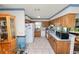Traditional kitchen showcases wood cabinets, white appliances, and tile flooring at 2103 Sylvester Ct, Lakeland, FL 33803