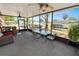 Enclosed lanai with patio furniture, fans, and views of the community, perfect for relaxing and entertaining at 2103 Sylvester Ct, Lakeland, FL 33803