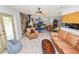 Open concept living room includes tile floors, a ceiling fan, and stone fireplace at 2103 Sylvester Ct, Lakeland, FL 33803