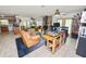 Spacious living room connects to the kitchen, featuring comfortable seating and a stone fireplace for cozy gatherings at 2103 Sylvester Ct, Lakeland, FL 33803
