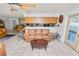 Open concept living room with tile floors flowing into dining area and comfortable seating at 2103 Sylvester Ct, Lakeland, FL 33803