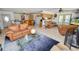 Open living area featuring a large sofa, a glass coffee table, and a view into the adjacent kitchen at 2103 Sylvester Ct, Lakeland, FL 33803