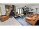 Cozy living room features a stone fireplace, tile floors, and comfortable seating, creating a warm and inviting atmosphere at 2103 Sylvester Ct, Lakeland, FL 33803