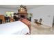 View of bedroom with brick fireplace, bed, and TV at 2103 Sylvester Ct, Lakeland, FL 33803