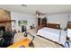 Large main bedroom has a brick fireplace, ceiling fan, and carpeted floors at 2103 Sylvester Ct, Lakeland, FL 33803
