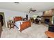 Spacious bedroom boasts a brick fireplace, ceiling fan, and a comfortable workspace area at 2103 Sylvester Ct, Lakeland, FL 33803