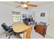 Bright office space features a ceiling fan, neutral walls, a large closet, and a table with office chairs at 2103 Sylvester Ct, Lakeland, FL 33803