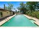 Inviting backyard pool with a surrounding concrete patio and verdant landscaping at 2103 Sylvester Ct, Lakeland, FL 33803