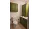 Bathroom featuring a toilet, tiled flooring and green cabinetry at 2213 Eastmeadows Rd, Lakeland, FL 33812