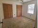 Bedroom featuring carpeted flooring, a window with blinds and double closet doors at 2213 Eastmeadows Rd, Lakeland, FL 33812