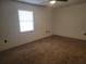 Bedroom with carpet flooring, a ceiling fan, and a bright window at 2213 Eastmeadows Rd, Lakeland, FL 33812