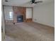 Cozy living room with carpet flooring, wood paneling, and a fireplace at 2213 Eastmeadows Rd, Lakeland, FL 33812