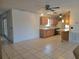 Open-concept living and kitchen area with tile flooring and wooden cabinets at 2213 Eastmeadows Rd, Lakeland, FL 33812