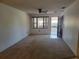 Bright living room with carpet flooring, ceiling fan, and natural light from the window at 2213 Eastmeadows Rd, Lakeland, FL 33812