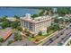 Aerial perspective of the building near the lake, featuring manicured lawns and palm trees at 235 6Th Nw St # 307, Winter Haven, FL 33881