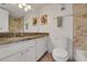 Well-lit bathroom features a granite countertop, updated fixtures, and a ceramic tiled shower at 235 6Th Nw St # 307, Winter Haven, FL 33881