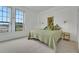 Well-lit bedroom features a large window with a view, neutral carpet, and a queen bed at 235 6Th Nw St # 307, Winter Haven, FL 33881