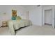 Bright bedroom featuring neutral carpet, a queen bed, and an attached closet for ample storage space at 235 6Th Nw St # 307, Winter Haven, FL 33881