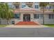 Stately building entrance with red-tiled steps and classic architectural details, including a covered entryway at 235 6Th Nw St # 307, Winter Haven, FL 33881