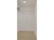 A simple walk-in closet featuring neutral carpet and basic wire shelving for storage at 235 6Th Nw St # 307, Winter Haven, FL 33881