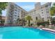 Resort-style community pool with ample seating and clear blue water, perfect for relaxation and recreation at 235 6Th Nw St # 307, Winter Haven, FL 33881