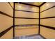 Interior view of an elevator featuring wood paneling and a stainless steel grab bar at 235 6Th Nw St # 307, Winter Haven, FL 33881