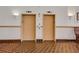 Hallway view of two elevators, tiled flooring, and sconce lighting at 235 6Th Nw St # 307, Winter Haven, FL 33881