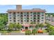 Attractive building exterior showcasing balconies, palm trees, and a welcoming entrance at 235 6Th Nw St # 307, Winter Haven, FL 33881