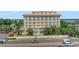 Charming building exterior showcasing a curved facade, landscaped grounds, and surrounding scenery at 235 6Th Nw St # 307, Winter Haven, FL 33881