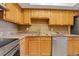 Bright kitchen features stainless steel appliances, light wood cabinets, and stone countertops at 235 6Th Nw St # 307, Winter Haven, FL 33881