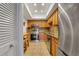 Well-lit kitchen featuring tile flooring, stainless steel appliances and wooden cabinetry at 235 6Th Nw St # 307, Winter Haven, FL 33881