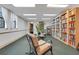 Community library with bookshelves, seating, and natural light from windows at 235 6Th Nw St # 307, Winter Haven, FL 33881