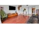 The living room features hardwood floors, modern décor, and is connected to the kitchen at 235 6Th Nw St # 307, Winter Haven, FL 33881