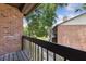 Exterior view of a brick-walled balcony overlooking lawn and trees at 2369 Tom Jones St # 8, Orlando, FL 32839