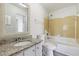 Bright bathroom featuring a vanity with granite countertops and tub with tiled walls at 2369 Tom Jones St # 8, Orlando, FL 32839