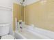 Full tub and toilet against a wall with colorful and retro tiling at 2369 Tom Jones St # 8, Orlando, FL 32839