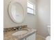 Cozy bathroom featuring an oval mirror, granite countertop, and a toilet at 2369 Tom Jones St # 8, Orlando, FL 32839