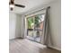 Bright bedroom with sliding glass doors to a balcony and a ceiling fan at 2369 Tom Jones St # 8, Orlando, FL 32839