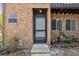 Close-up of the exterior entrance with red brick facade and well-maintained landscaping at 2369 Tom Jones St # 8, Orlando, FL 32839