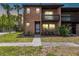 Charming brick condo with a cozy balcony, lush landscaping, and sidewalk leading to the front entrance at 2369 Tom Jones St # 8, Orlando, FL 32839