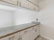 Bright kitchen featuring granite countertops and white cabinetry, offering a clean and modern aesthetic at 2369 Tom Jones St # 8, Orlando, FL 32839
