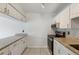 Functional kitchen featuring granite countertops, a black stove, and ample white cabinet space at 2369 Tom Jones St # 8, Orlando, FL 32839
