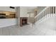 Bright living room with brick fireplace, tile flooring, and staircase leading to the upper level at 2369 Tom Jones St # 8, Orlando, FL 32839