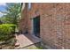 Brick patio with sliding glass doors and adjacent green lawn for relaxation and entertainment at 2369 Tom Jones St # 8, Orlando, FL 32839