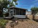 This home has a screened in porch and overgrown yard at 2610 Eaton Ave, Lakeland, FL 33803