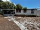 The backyard features scattered debris, disrepair, and a partially overgrown yard at 2610 Eaton Ave, Lakeland, FL 33803