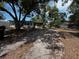 The backyard features overgrown areas mixed with sandy ground at 2610 Eaton Ave, Lakeland, FL 33803