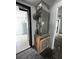 Utility closet with large hot water heater, AC unit and new tiled floor with access to another room at 2610 Eaton Ave, Lakeland, FL 33803