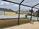 View of backyard from screened-in porch and white vinyl fence in the distance at 2663 Brookside Bluff Loop, Lakeland, FL 33813